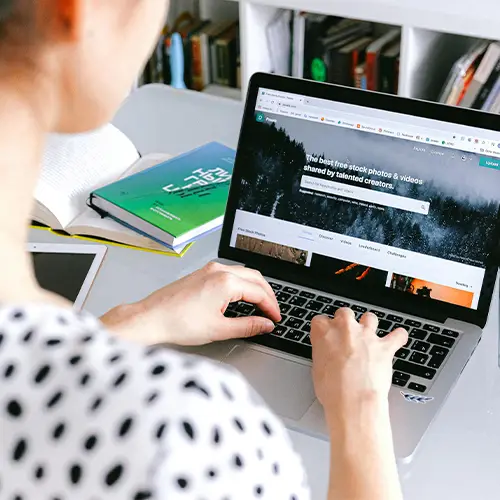 a woman typing on a laptop